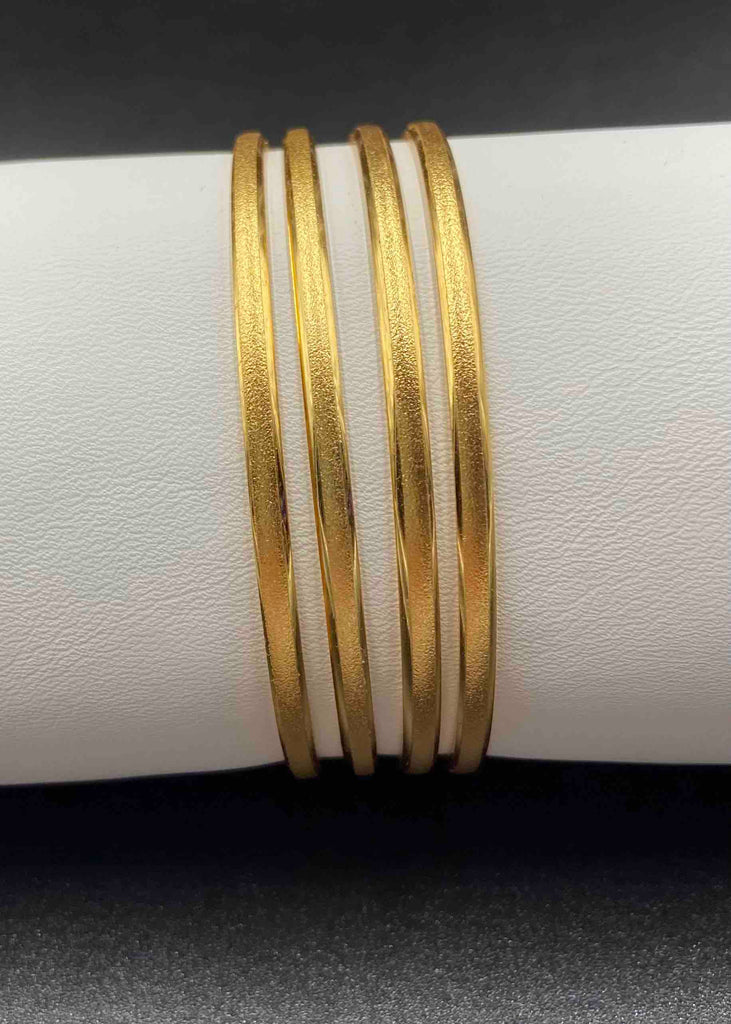 Set of four plain gold bangles