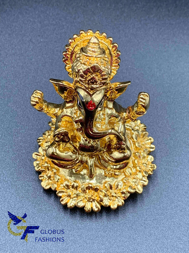 Flower design base with gold Ganesha idol