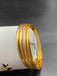 Set of four plain gold bangles